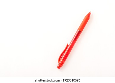 Red ballpoint pen. White background.