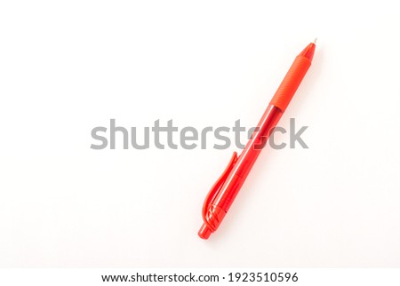 Red ballpoint pen. White background.