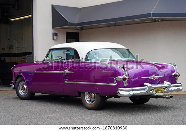 RED BANK, NJ –16 JUL 2020- View of a purple\
vintage Packard car with chrome bumpers at a service station in Red\
Bank, Monmouth County, New\
Jersey.