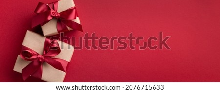 Red banner with two gift boxes tied red ribbons.