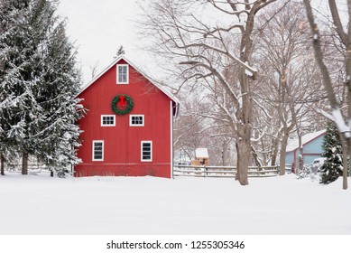 Red barn with Christmas wreath on snowy midwestern day - Powered by Shutterstock