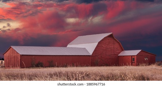 Red Barn With Dark Red And Grey Clouds In Late Autumn