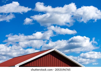 Red Barn Roof Against A Blue Sky