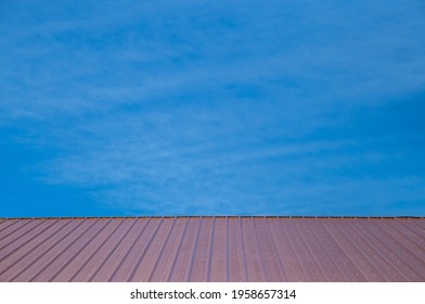 Red Barn Roof With Bright Blue Sky