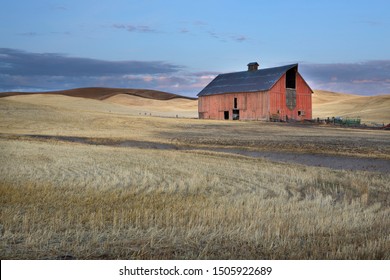 A red barn stands in the harvested wheat field in the Palouse region of eastern Washington.
