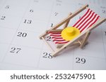 Red beach chair and hat on white blank calendar background copy space. Annual leave travel period for relaxation concept. Period of paid time off (PTO) granted to employees by their employer.