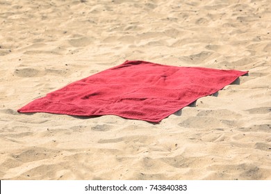 Red Beach Towel On Sand