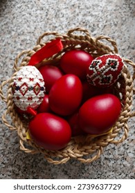 red and bead decorated easter eggs in a wicker basket 