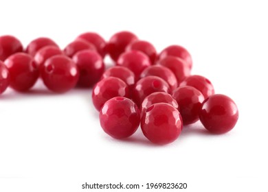 Red Beads spread on white background. Background or texture of beads.Close up,used in finishing fashion clothes. make bead necklace or string of beads for women of fashion,Bead Crochet. Daily Beading.