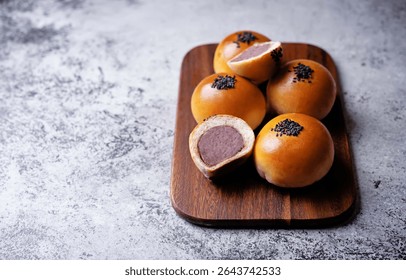 Red bean paste buns with black sesame seeds sprinkles. toning