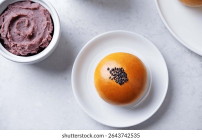 Red bean paste buns with black sesame seeds sprinkles. toning