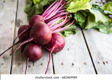 Red Beetroot with herbage green leaves on rustic background. Organic Beetroot. - Powered by Shutterstock