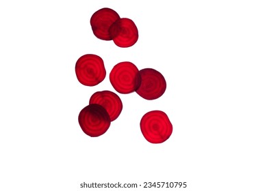 Red beetroot round slice on white background, top view, flat lay. Backlit transparent abstract fresh slices organic vegetables. . High quality photo - Shutterstock ID 2345710795