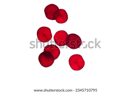 Red beetroot round slice on white background, top view, flat lay. Backlit transparent abstract fresh slices organic vegetables. . High quality photo