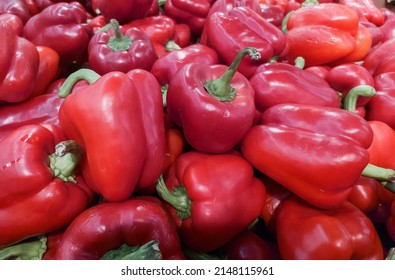 Red Bell Peppers On A Counter In The Supermarket. A Large Number Of Red Peppers In A Pile. Assortment Of Shops And Market. Background. View From Above. Vegetables. Agriculture.