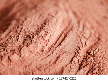 Red bentonite clay powder. Natural beauty treatment and spa. Clay texture close up, selective focus.
