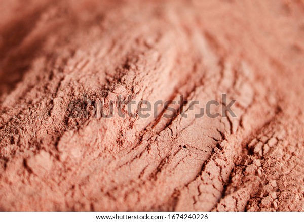 Red bentonite clay
powder. Natural beauty treatment and spa. Clay texture close up,
selective focus.
