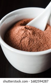 Red Bentonite Clay Powder In The White Bowl, Close Up. Diy Facial Mask And Body Wrap Recipe. Natural Beauty Treatment And Spa.