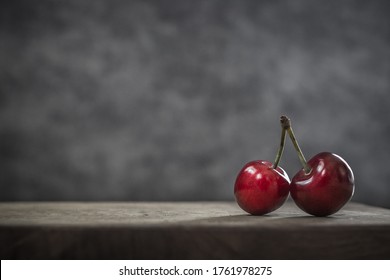 Red Berries. Ripe Sweet Cherries. Food That Is Good For The Brain Improves Memory And Skin. Retinol-rich Foods. Two Cherries On One Branch. Object Shooting. Still Life In Fashion Style. Red On Gray.