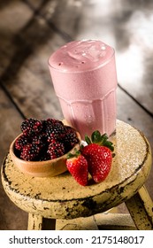 Red Berries Smoothie With A Bowl Of Blackberries And Strawberries Aside, On A Wooden Table