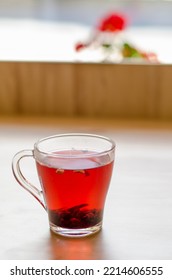 Red Berry Tea In A Transparent Cup On The Background Of A Wooden Table In A Cafe