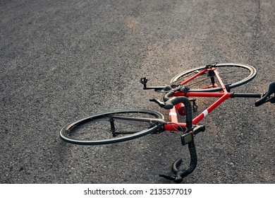 Red Bicycle Lies On Pavement On Roadway Surface. Concept On Theme Of Accident. Copy Space. Red Sportive Bike, No People. Active Lifestyle, Bike, Bicycle