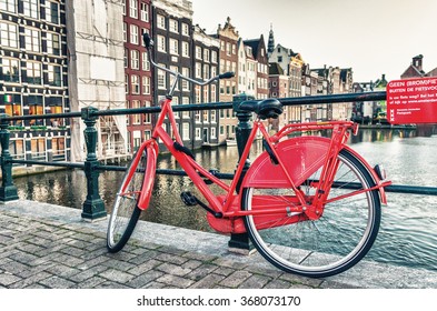 Red Bike Parked Along Amsterdam Canal.