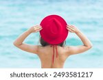 Red Bikini Women relax on paradise beach. Cheerful woman walking on beach in bikini swimwear smile happiness face look at camera. Tropical summer beach island white sand blue sea. Beautiful landscape