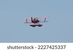 Red biplane with floats for water landing