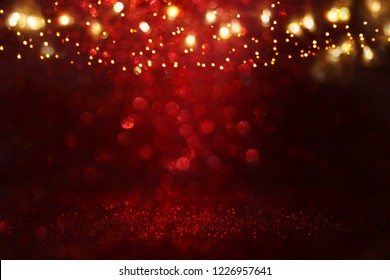 Red, Black And Gold Glitter Lights Background. Defocused