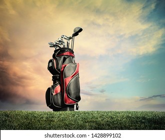 Red And Black Golf Bag With Clubs On Grass Against Dramatic Clouds