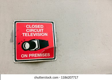 Red Black White Broken Old Sign Closed Circuit Television On Premises Warning With Camera Icon