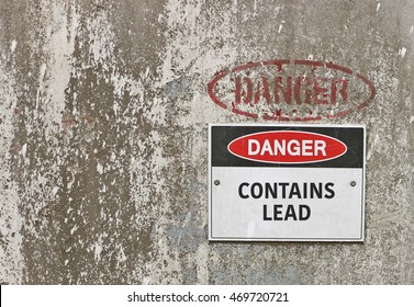 red, black and white Danger, Contains Lead warning sign