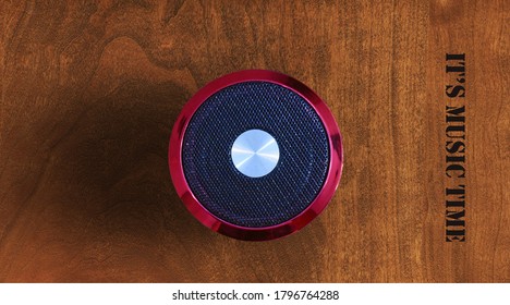 Red Black Wireless Bluetooth Speaker On Wooden Desk Top View