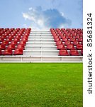 Red bleachers with green field background
