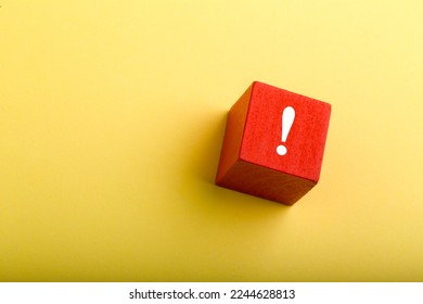 Red block with exclamation mark isolated on yellow background with copy space.