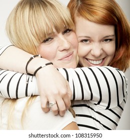 Red And Blond Haired Girls Friends Laughing And Hug