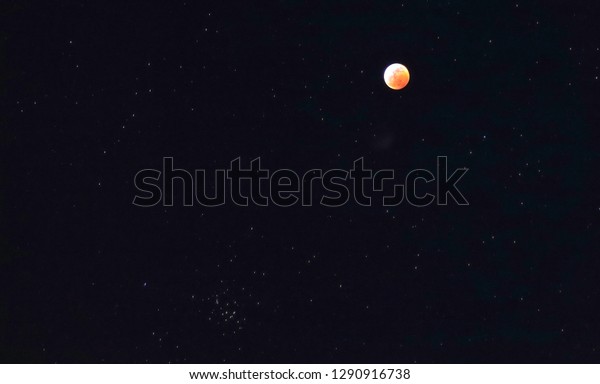 Red (blood) moon and stars in the sky during\
total moon eclipse January 20,\
2019
