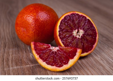 Red Blood Sicilian Orange Whole, Half And Wedge On Wooden Background