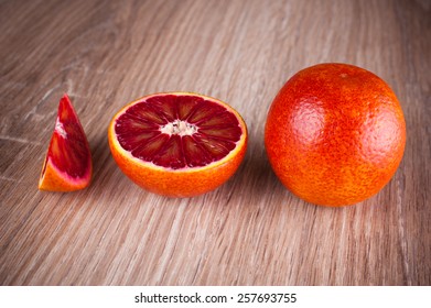 Red Blood Sicilian Orange Whole, Half And Wedge On Wooden Background