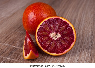 Red Blood Sicilian Orange Whole, Half And Wedge On Wooden Background