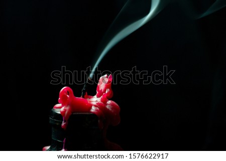 Red blown out candle  black background