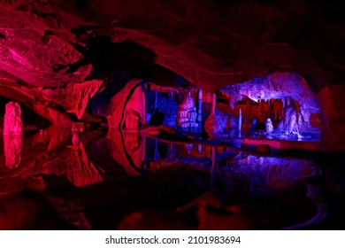 A red and blue cave in Cheddar Gorge, Somerset, England, UK - Shutterstock ID 2101983694