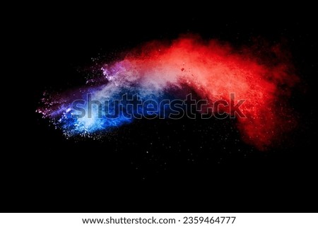 Red blue dust particles explosioon on black background.Red blue powder splash.