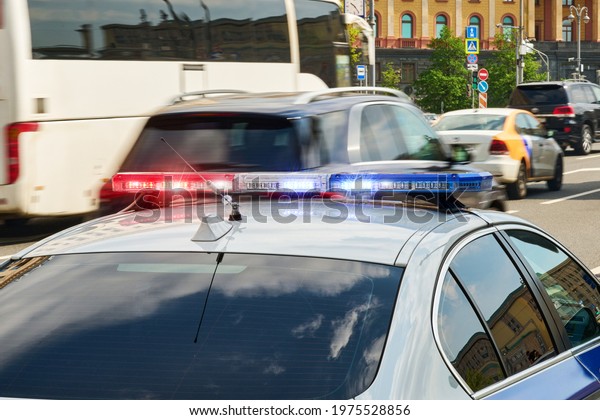 Red and blue\
flashing lights on police\
car.