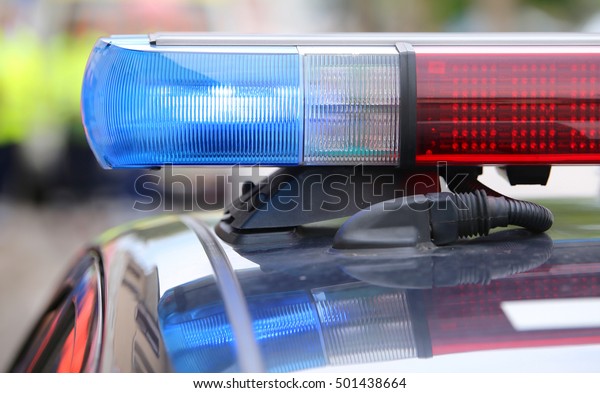 red and blue flashing lights\
on the police car during the reconnaissance in the\
city