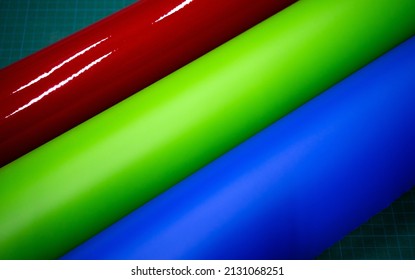 Red, Blue, Green Vinyl Film On The Table. Automotive Plastic Film For Car Tuning And Design.