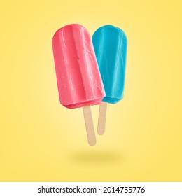 Red And Blue Ice Creams Flying On Yellow Background With Copy Space. Summer Background