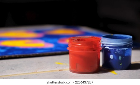 Red   blue jar acrylic gouache paints close  up  Painted picture the background  Creative painting hobby  Child drawing Mothers fathers day card  Artistic pasttime  Side view  Objects 