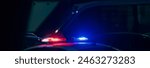 Red and blue lights of a police car close up in the evening, stock photo